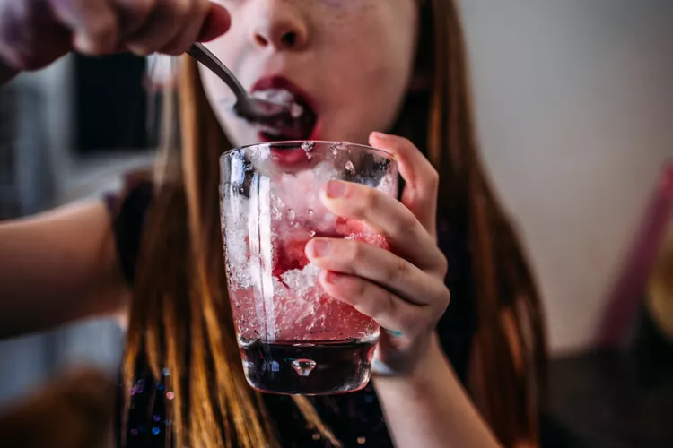 young-girl-eating-a-home-made-snow-cone-1352036433-b95fb29582ae493e8844a8a3b342218a