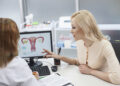 Beautiful blond girl is consulting with gynecologist