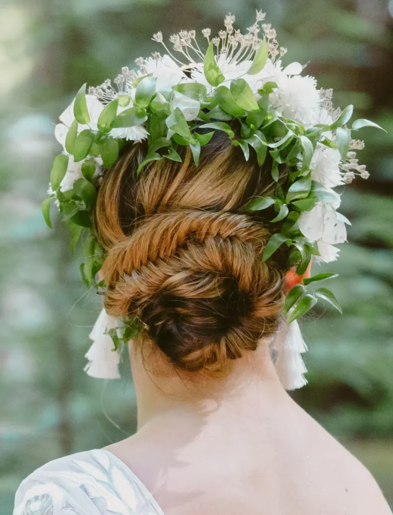 elegant-chignon-bun-best-braided-wedding-hair-with-boho-floral-hairpiece