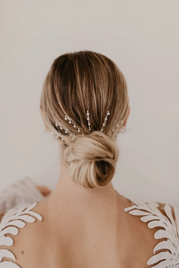 elegant-low-chignon-bun-best-wedding-hair-with-pearl-barrettes